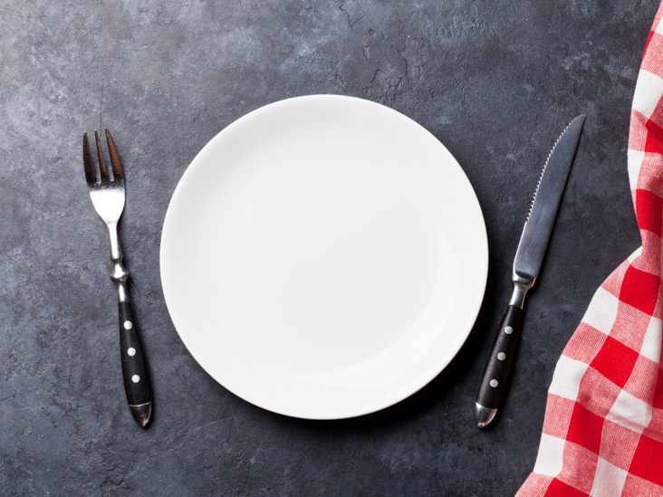 Empty plate and kitchen towel